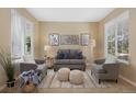 Comfortable living room with neutral tones, stylish seating, and lots of light at 4821 Bluegate Dr, Highlands Ranch, CO 80130