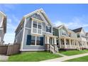 Lovely blue home featuring modern architectural details, including stylish windows and a well-kept yard at 223 Washington St, Erie, CO 80516