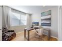 Bright home office with a modern desk, stylish chair, and large window providing ample natural light at 7734 Terry Ct, Arvada, CO 80007