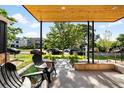 Inviting front porch with wood ceiling and seating area, perfect for enjoying the neighborhood views at 4131 Osage St, Denver, CO 80211