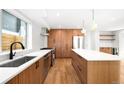 Well-lit kitchen showcases wood cabinets, stainless steel appliances, an island, and hardwood floors at 4131 Osage St, Denver, CO 80211
