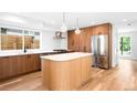 Modern kitchen features sleek wood cabinets, stainless steel appliances, and a stylish central island at 4131 Osage St, Denver, CO 80211