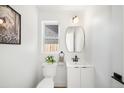 Chic powder room with modern vanity, sleek mirror, and elegant fixtures in a neutral color scheme at 4131 Osage St, Denver, CO 80211
