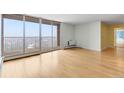 Sun-drenched living area with wood floors, floor-to-ceiling windows, and access to a private balcony, perfect for entertaining at 955 Eudora St # 1106, Denver, CO 80220