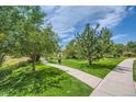 Community park with a sidewalk and newly cut grass, providing a serene atmosphere at 22580 E Ontario Dr # 202, Aurora, CO 80016