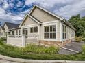 View of home with stone accents, and landscaping at 6924 W Euclid Pl # A, Littleton, CO 80123