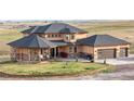 This charming home boasts a large front yard, covered porch, and three-car garage, perfect for families at 942 S County Road 129 Rd, Bennett, CO 80102