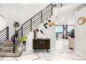 Grand foyer with modern staircase, stylish console table, and elegant decor creates a welcoming entrance at 942 S County Road 129 Rd, Bennett, CO 80102