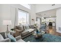 Bright living room featuring a large window and hardwood floors at 14881 E 117Th Ave, Commerce City, CO 80603