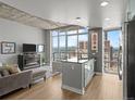 Bright living room with floor-to-ceiling windows offering city views at 891 14Th St # 2505, Denver, CO 80202