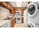 Efficient kitchen features white appliances, including a dishwasher, microwave, and stove oven at 8025 W Eastman Pl # 2-102, Lakewood, CO 80227