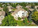 An eye-level view shows the deck of the two-story home with beautiful landscaping and a well-maintained yard at 9556 Kemper Dr, Lone Tree, CO 80124