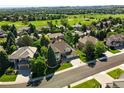 A beautiful aerial view of a home with a well-manicured lawn near a lush golf course and neighborhood at 9556 Kemper Dr, Lone Tree, CO 80124
