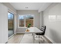 Well-lit home office with a large window, modern desk, and access to a patio for a refreshing work environment at 3820 Jason St # 3, Denver, CO 80211