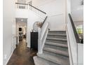 Bright entryway with a staircase and slate tile, leading to the living areas of the home at 5265 S Cathay Way, Centennial, CO 80015