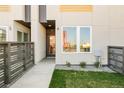 Inviting entrance to a modern home with a well-manicured lawn and contemporary wooden fence at 2105 S Galapago St # 4, Denver, CO 80223