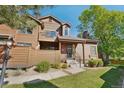 Attractive townhouse with wood facade, small porch and landscaped front yard and walkway at 9455 W 81St Ave # A, Arvada, CO 80005