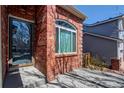 Inviting front porch area with brick accents and a glass front door, adding charm to the entrance at 10486 Cheetah Winds, Lone Tree, CO 80124