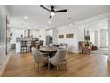 Open-concept dining area featuring wood floors, a ceiling fan, and seamless transition to kitchen at 42978 Colonial Trl, Elizabeth, CO 80107