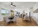 Bright dining area with views, showcasing open layout, wood floors, and contemporary lighting at 42978 Colonial Trl, Elizabeth, CO 80107