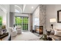 Bright living room featuring a tile fireplace, large windows, and comfortable seating at 345 Fillmore # 407, Denver, CO 80206