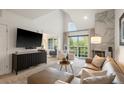 Bright living room with high ceilings, fireplace, large windows, and comfortable seating at 345 Fillmore # 407, Denver, CO 80206
