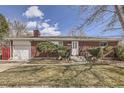 Charming brick ranch home with a well-manicured front lawn and a garage at 6140 Depew St, Arvada, CO 80003