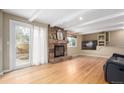 Inviting living room with hardwood floors, stone fireplace, and natural light from sliding glass door at 8970 Garland Ct, Westminster, CO 80021