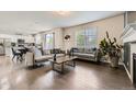 Spacious living room featuring hardwood floors and an open layout at 6108 S Harvest Ct, Aurora, CO 80016