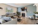 Cozy living room features a fireplace, large window, and stylish decor at 6108 S Harvest Ct, Aurora, CO 80016