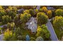 Stunning aerial view of a house nestled among mature trees in a serene neighborhood setting at 1350 E Greenwood Ln, Greenwood Village, CO 80121