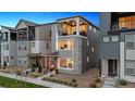 Modern multi-story home with a private balcony, stone accents, and low-maintenance landscaping at 12270 W 57Th Ave, Arvada, CO 80002