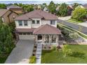 Two-story home with a stone-accented porch at 10559 Sedalia St, Commerce City, CO 80022