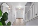 Bright and airy entryway with hardwood floors and staircase at 1143 Autumn Star Pt, Monument, CO 80132