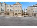 Front view of tan townhome with two-car garage at 1143 Autumn Star Pt, Monument, CO 80132