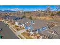 Aerial view of a charming home featuring a well-maintained lawn and beautiful landscaping in a suburban neighborhood at 12957 W 78Th Cir, Arvada, CO 80005