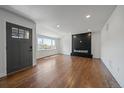 Bright living room featuring hardwood floors, a cozy fireplace, and large windows with a view at 716 S Osage St, Denver, CO 80223