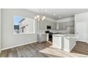 Spacious kitchen with grey cabinets, stainless steel appliances, a large island, and a bright window at 16840 Mckay Dr, Mead, CO 80542