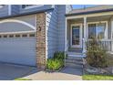 Close up of front entrance of the home with a charming front porch with brick siding at 3734 Licorice Trl, Castle Rock, CO 80109