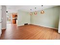 The dining room features modern lighting and hardwood floors at 15895 E 17Th Pl, Aurora, CO 80011