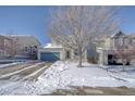 Two-story house with a teal garage door and snow-covered front yard at 2959 Skyward Way, Castle Rock, CO 80109