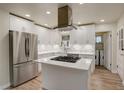 Modern kitchen with white cabinets, stainless steel appliances, and island at 4324 Eaton St, Denver, CO 80212