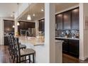 Modern kitchen with stainless steel appliances, granite countertops, and a stylish backsplash at 848 Sandstone Cir, Erie, CO 80516