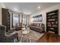 Cozy living room with comfortable seating, stylish decor, and natural light from the large windows at 848 Sandstone Cir, Erie, CO 80516
