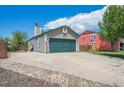 Exterior view of house with a spacious driveway leading to the two-car garage at 11337 E 1St Ave, Aurora, CO 80010