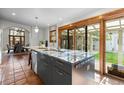 Kitchen island with granite countertops, stainless steel appliances, and access to backyard patio at 4525 King St, Denver, CO 80211