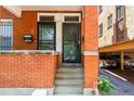 Close-up of a townhouse entrance with steps leading to double doors and a view of covered parking at 1243 N Lafayette St, Denver, CO 80218