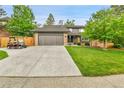 Charming two-story house with well-kept lawn, two car garage, and golf cart at 11209 Quivas Loop, Denver, CO 80234