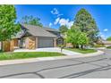 A beautiful two-story home shows off its well-maintained lawn, driveway, and landscaping at 11209 Quivas Loop, Denver, CO 80234