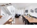 Open concept dining area with modern light wood table and black chairs at 62 N Jasmine St, Denver, CO 80220